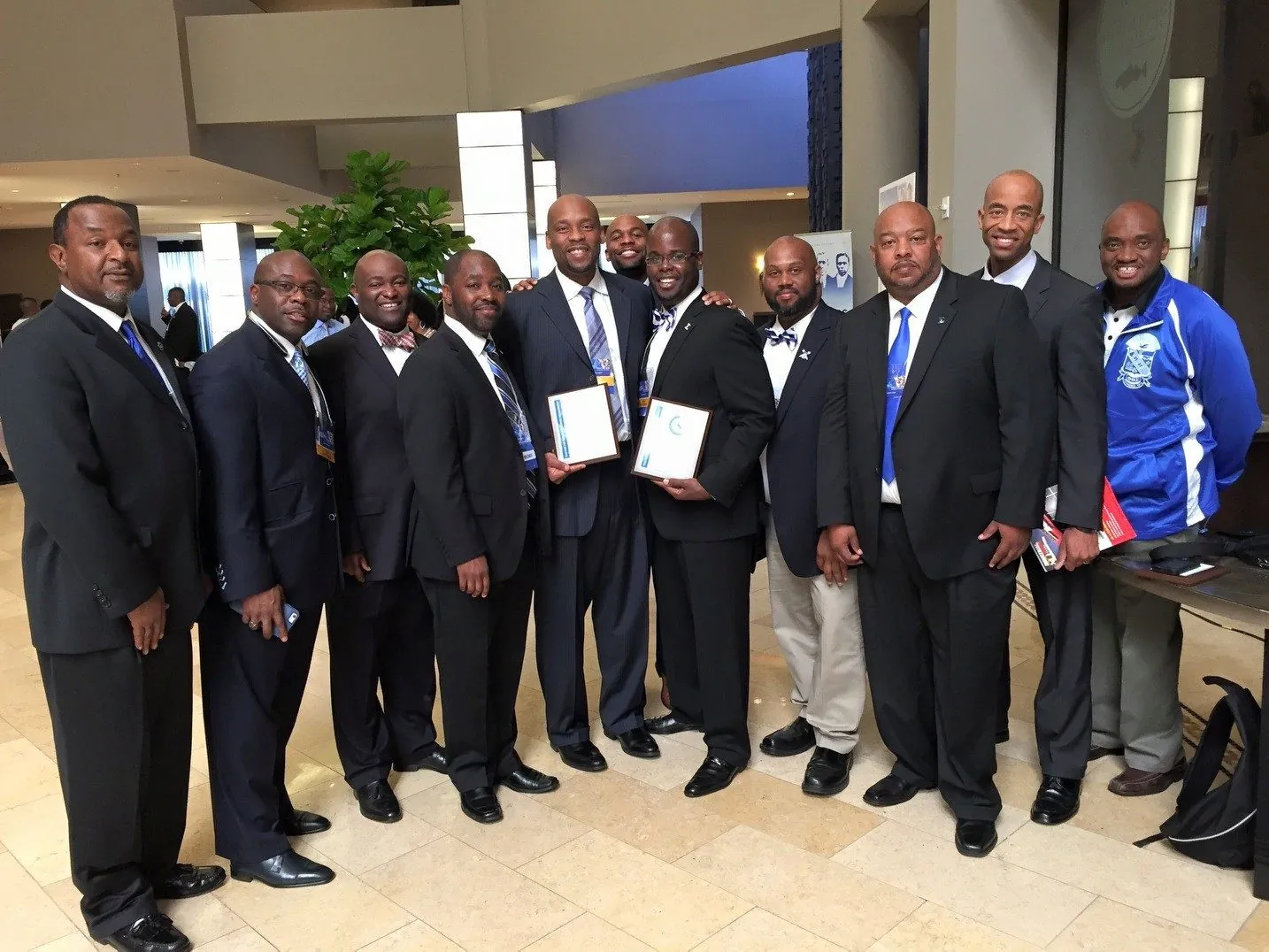 Chapter brothers with a presented certificate