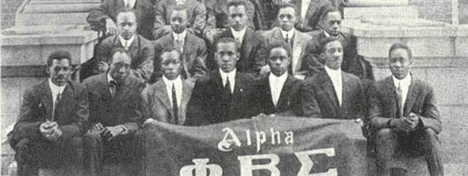 The Founders of Phi Beta Sigma Fraternity, Inc. with the Alpha Chapter banner at Howard University, 1914
