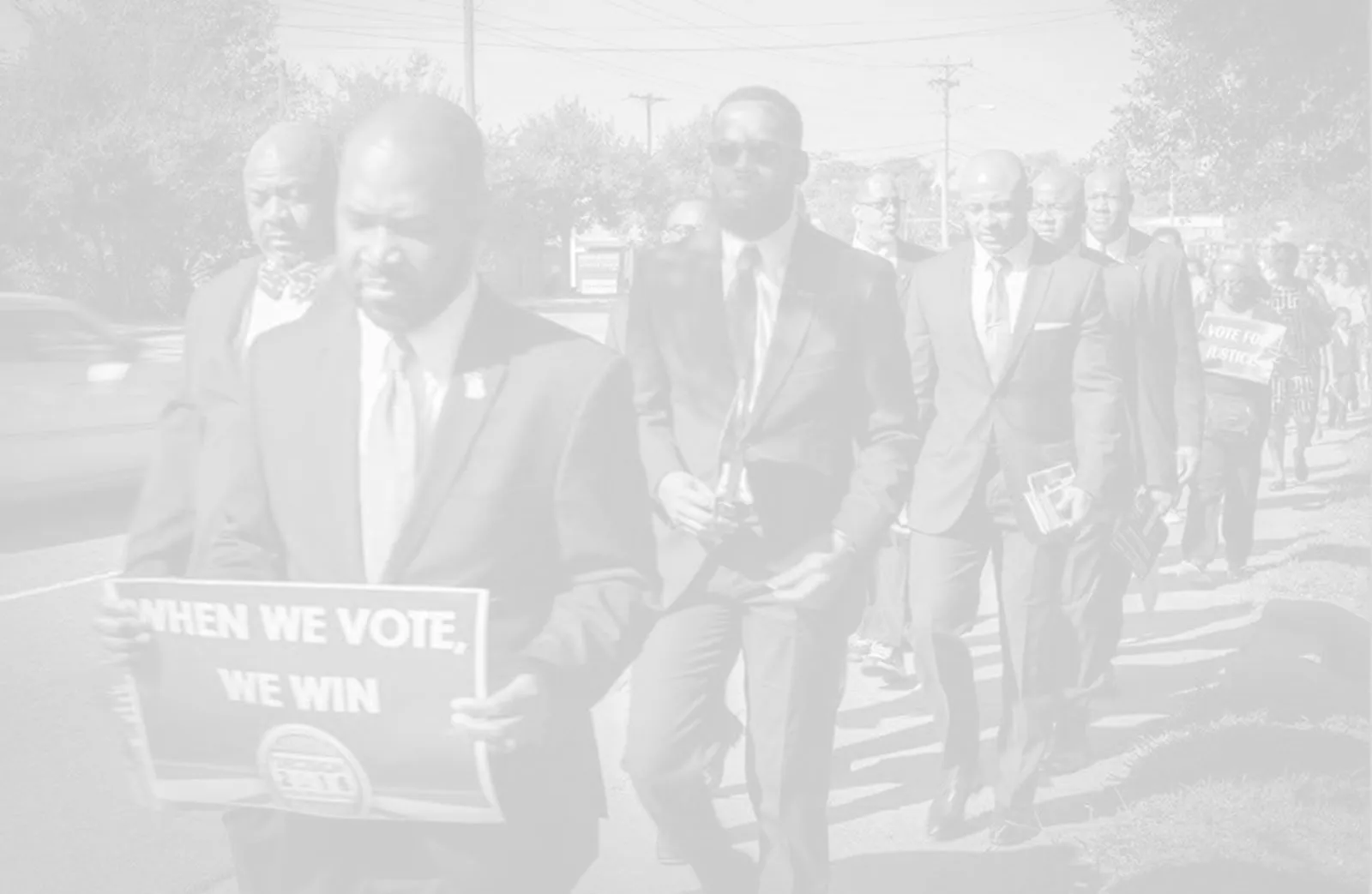 Brothers marching in a voter engagement demonstration — "When We Vote, We Win"